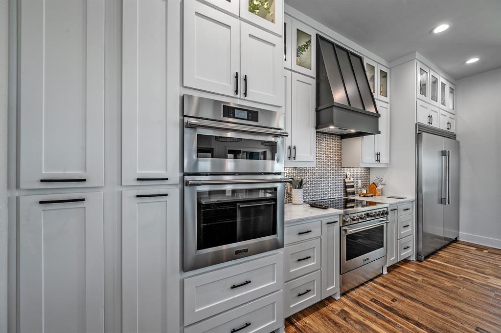 4509 Peach Tree Lane Kingston, OK 73439 - Photo 21 of 39 a kitchen with stainless steel appliances white cabinets and a stove top oven