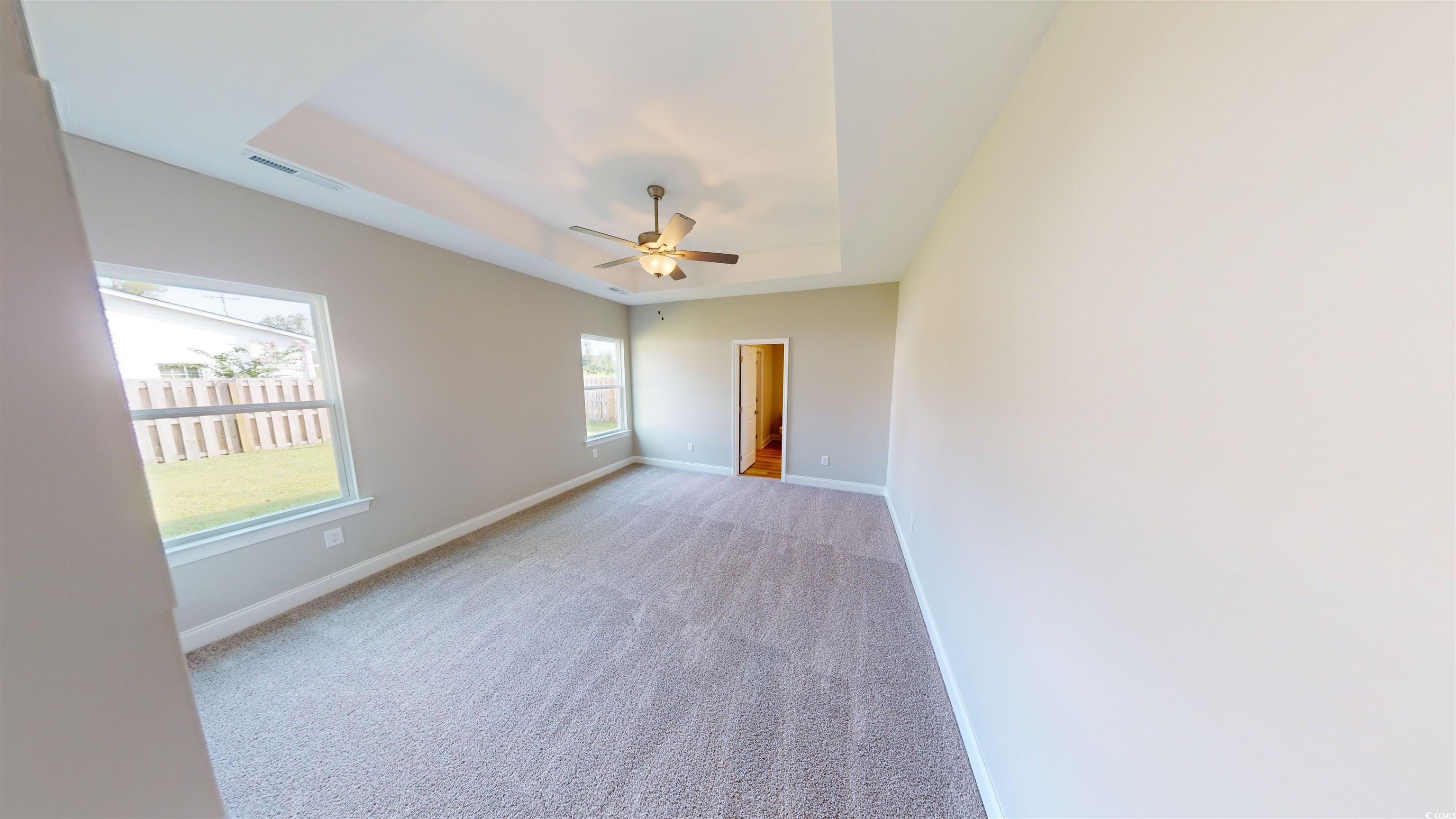 1044 Moen Loop, Unit LOT 12 Conway, SC 29526 - Photo 11 of 16 Carpeted empty room with a tray ceiling and ceiling fan