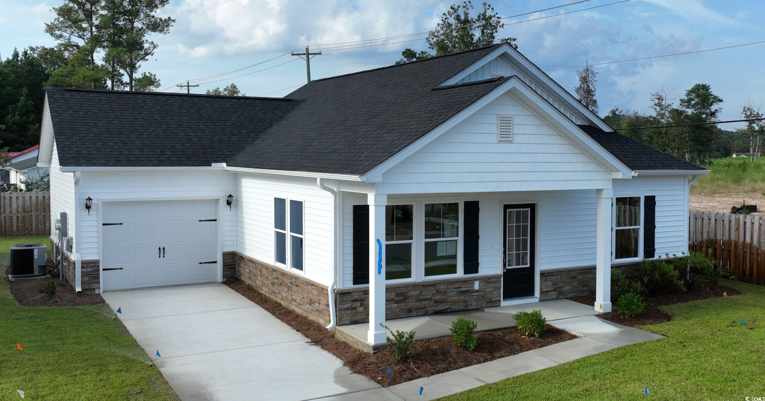 1044 Moen Loop, Unit LOT 12 Conway, SC 29526 - Photo 15 of 16 View of front of property with covered porch, a garage, stone siding, concrete driveway, and a shingled roof