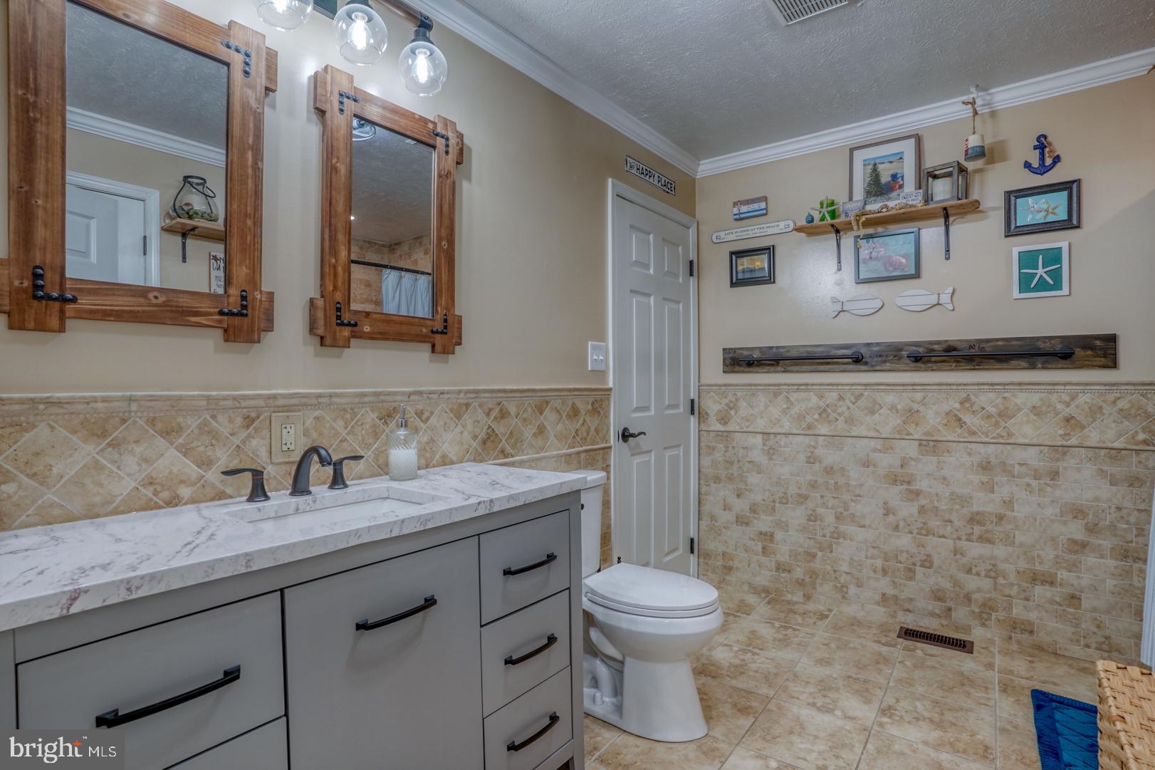 212 Mike Drive Elkton, MD 21921 - Photo 26 of 39 a bathroom with a granite countertop sink mirror vanity and toilet