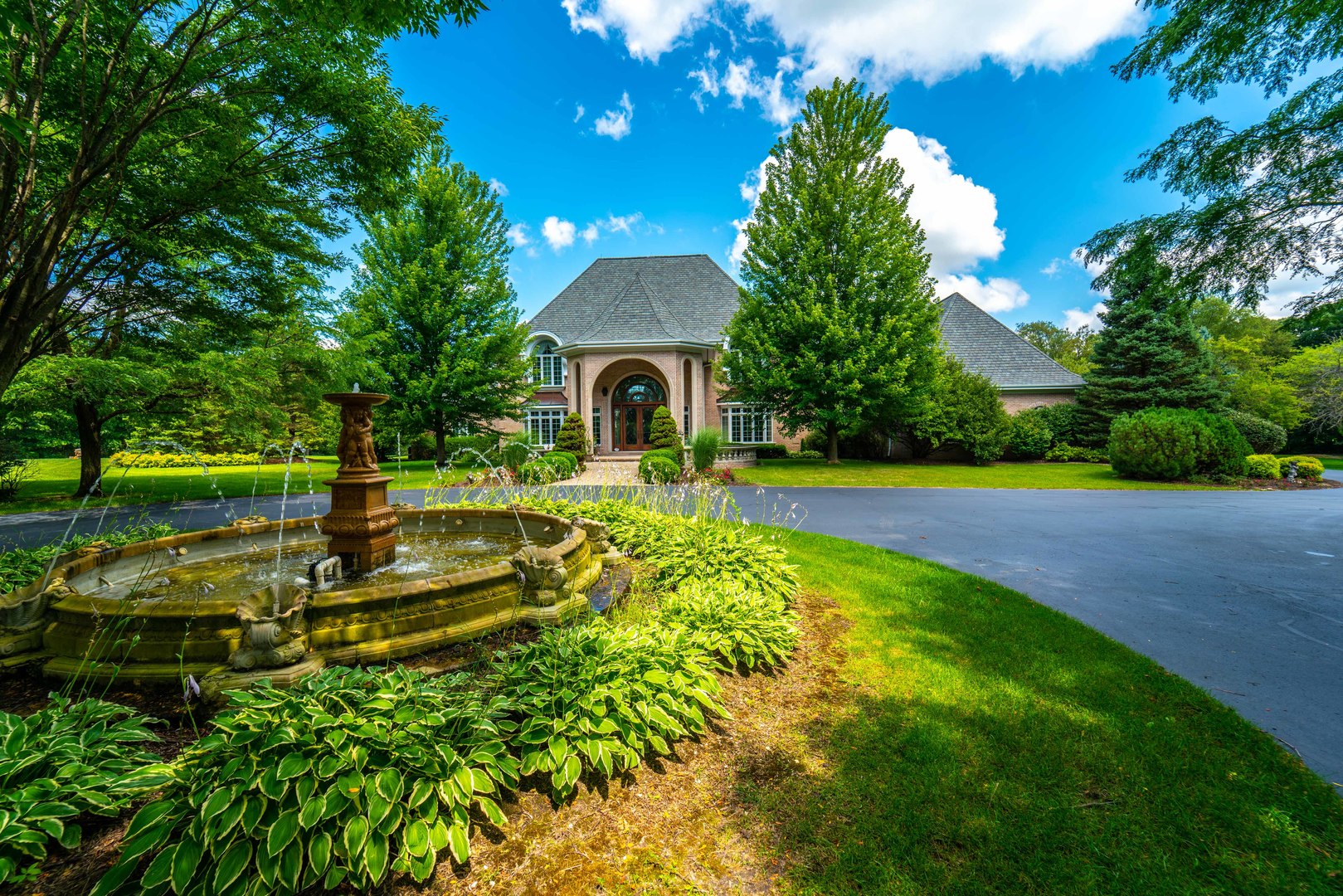 a view of a house with backyard and a patio