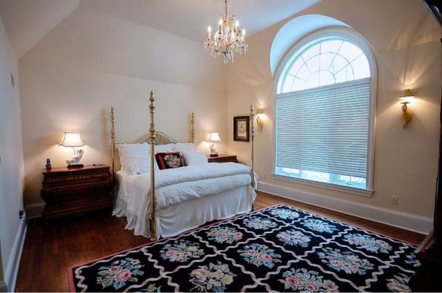 228 East Goodenow Road Beecher, IL 60401 - Photo 35 of 79 a bedroom with a bed and a chandelier