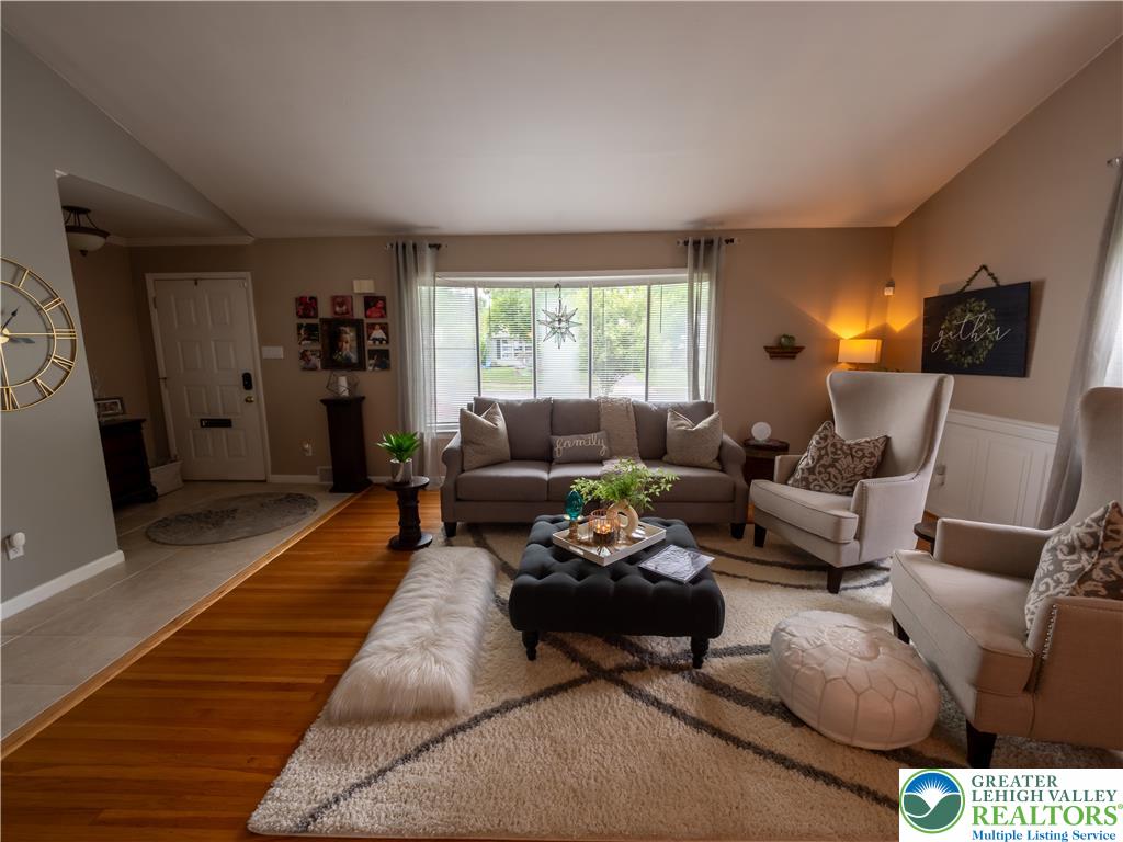 2087 Hopewell Road Bethlehem, PA 18017 - Photo 10 of 38 Hardwood flooring extends throughout this naturally illuminated living area, offering a warm and inviting atmosphere.
