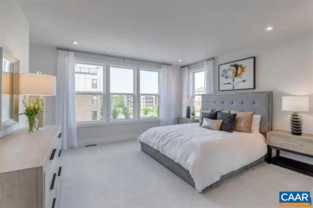 a bedroom with a large bed and a window