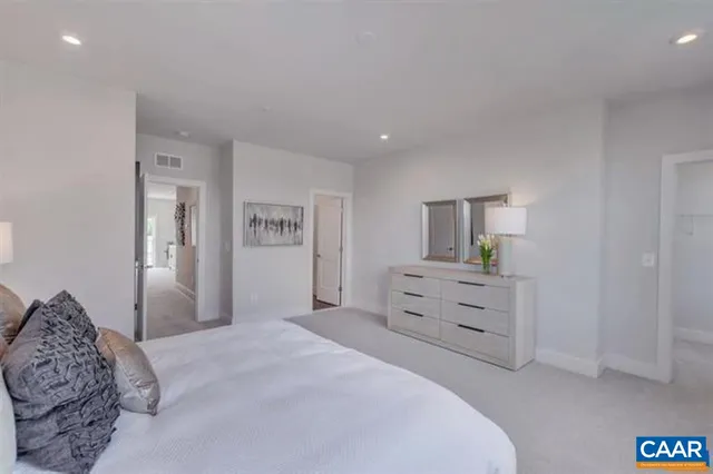 a bedroom with a bed and a dresser