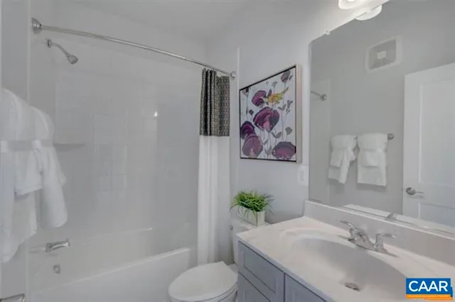 a bathroom with a granite countertop sink a toilet and a bathtub