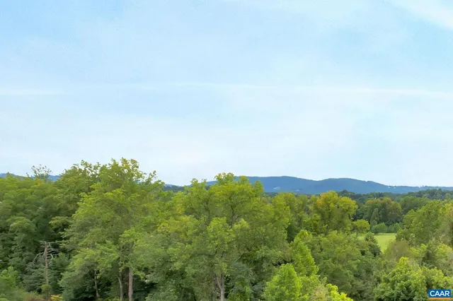 a view of a mountain range with lush green forest