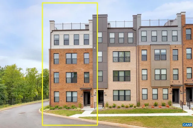 a front view of a building with a yard