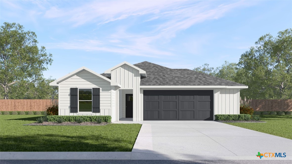 a front view of a house with a garden and yard