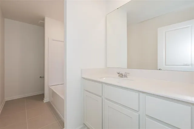 a view of an house with backyard and a tree