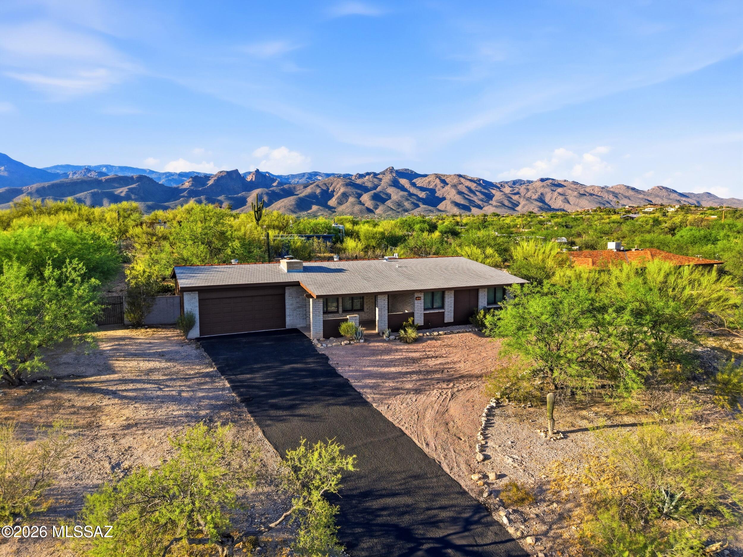 9141 East Indian Canyon Road Tucson, AZ 85749 - Photo 3 of 33 a view of a house with a yard