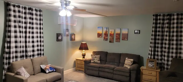 a living room with furniture and a flat screen tv