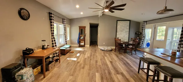 a view of a livingroom with furniture and a floor to ceiling window