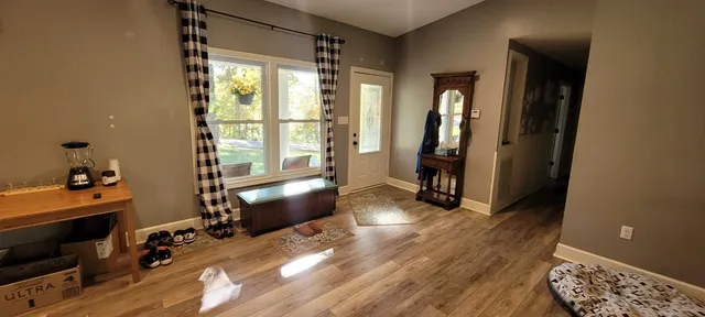 a view of a hallway with workspace and a window