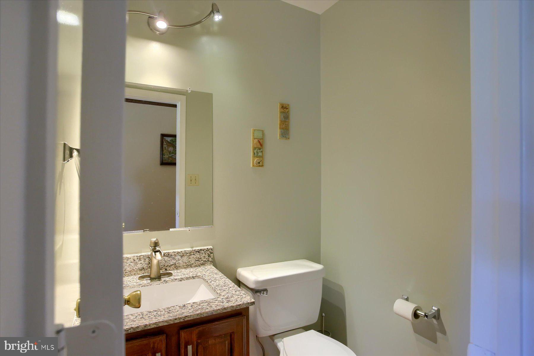 908 Sunnyside Road Hummelstown, PA 17036 - Photo 16 of 41 a bathroom with a granite countertop toilet a sink and a mirror