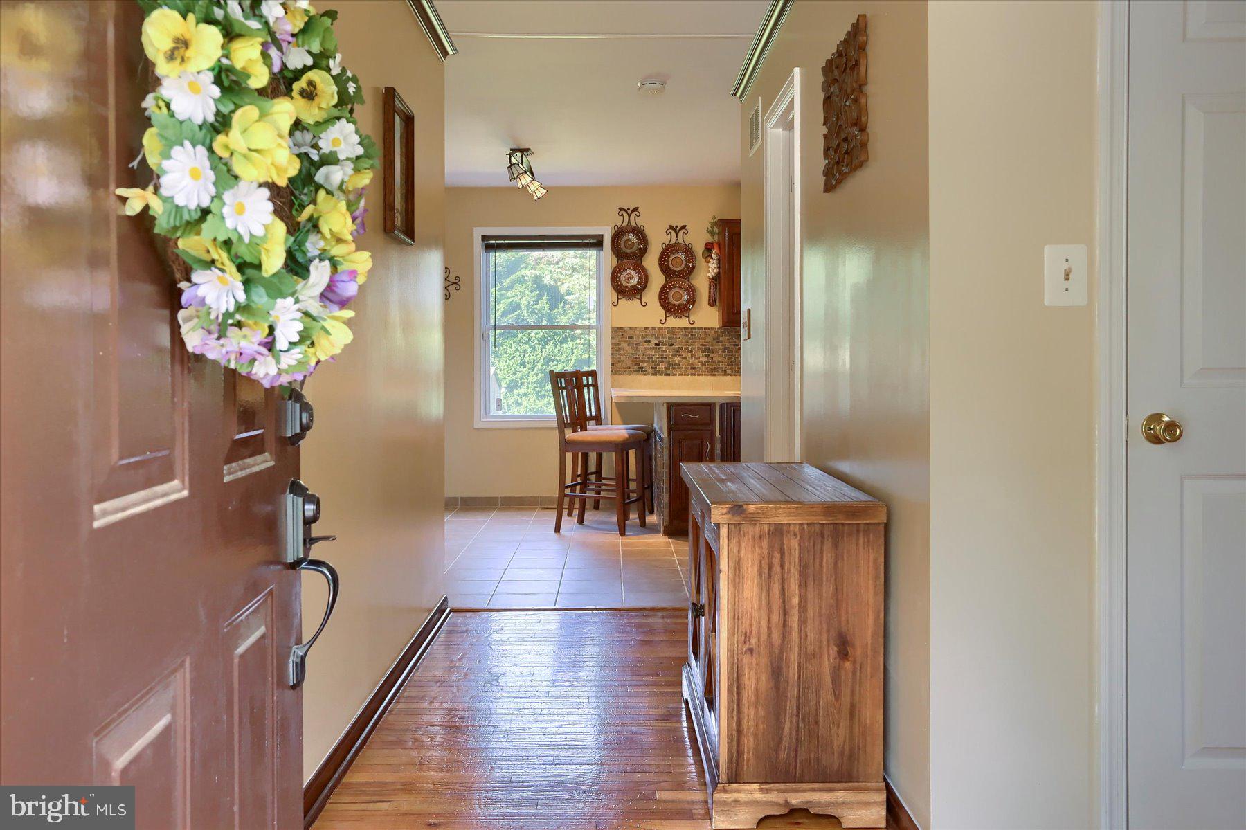 908 Sunnyside Road Hummelstown, PA 17036 - Photo 5 of 41 a dining room with chandelier and wooden floor