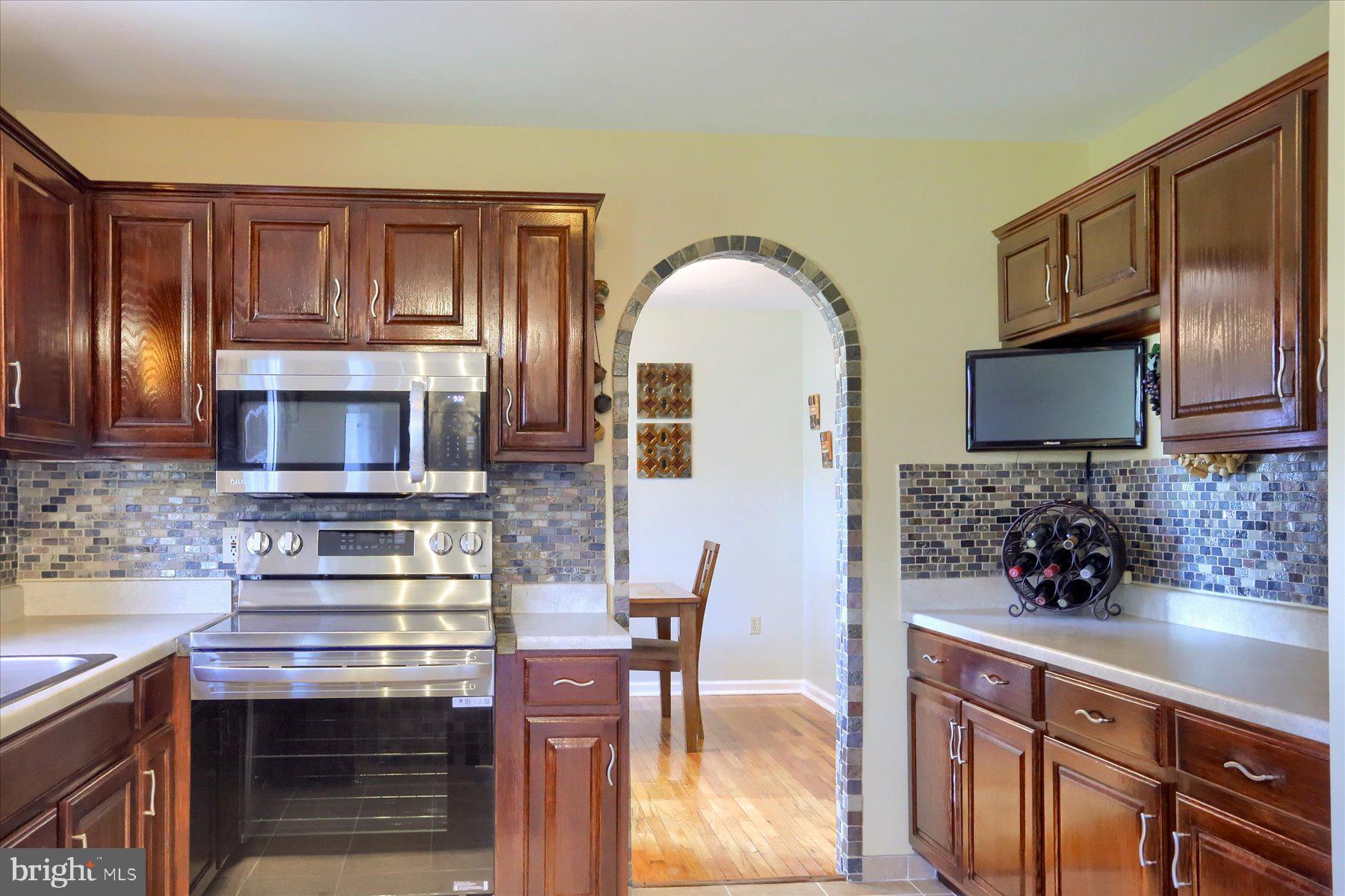 908 Sunnyside Road Hummelstown, PA 17036 - Photo 7 of 41 a kitchen with stainless steel appliances granite countertop a stove microwave and cabinets