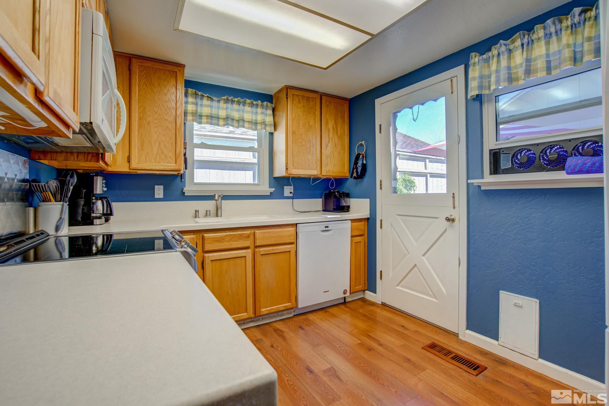 1208 Laredo Court Reno, NV 89503 - Photo 12 of 30 a kitchen with granite countertop a sink a counter space and cabinets