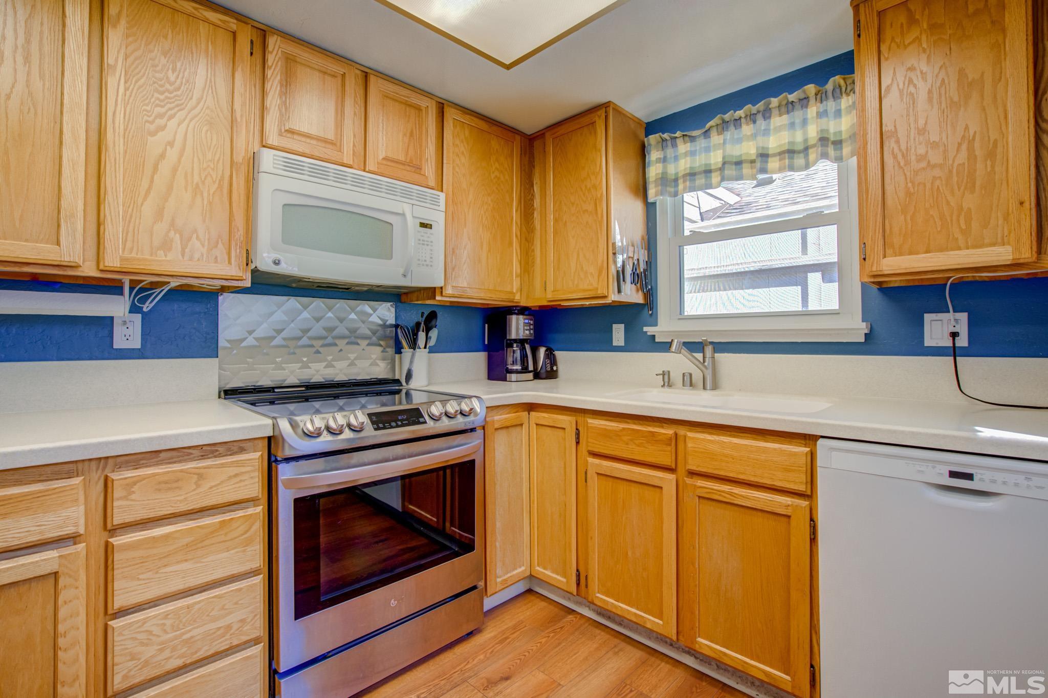 1208 Laredo Court Reno, NV 89503 - Photo 13 of 30 a kitchen with granite countertop cabinets stainless steel appliances a sink and a window