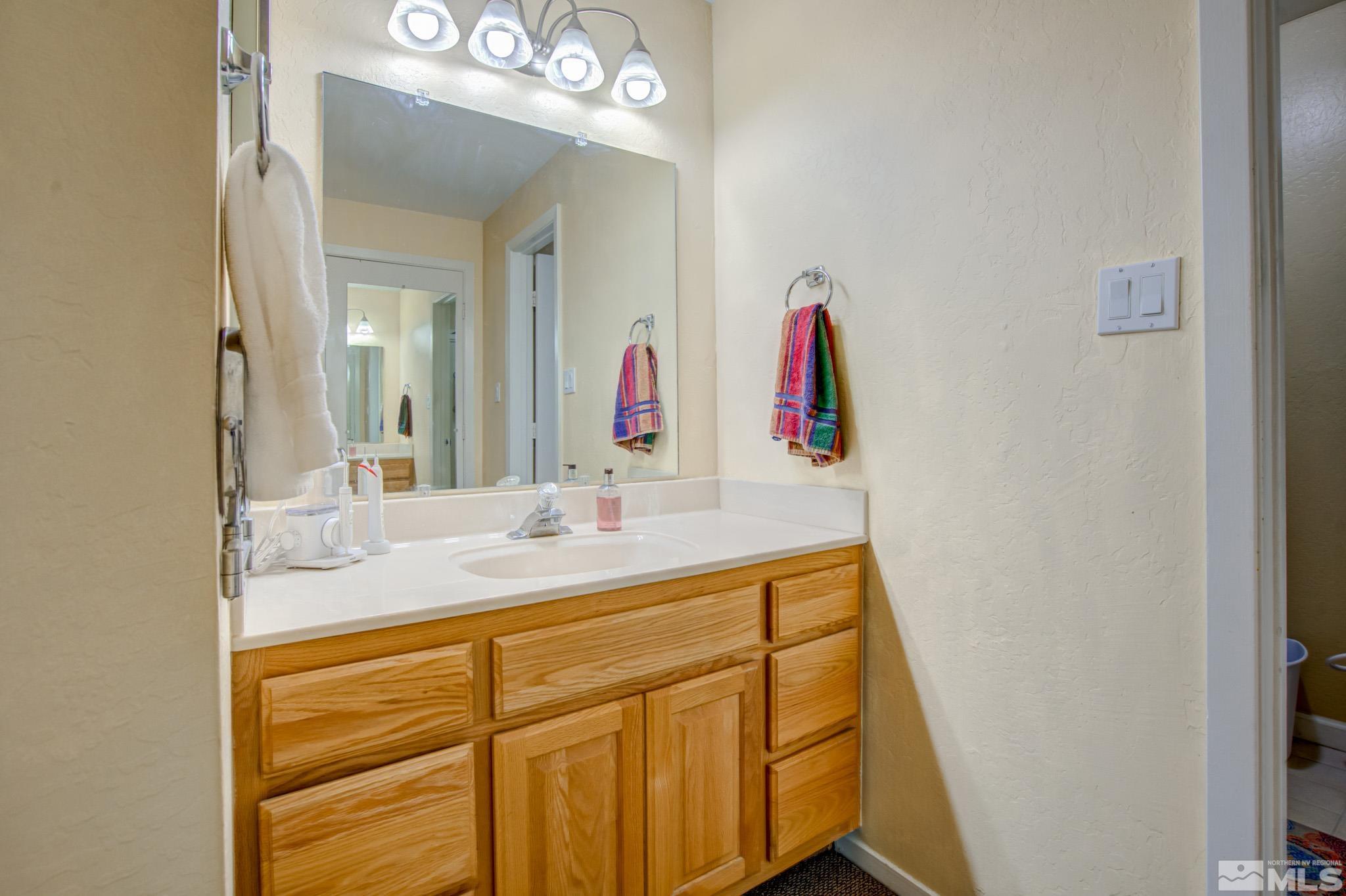 1208 Laredo Court Reno, NV 89503 - Photo 19 of 30 a bathroom with a sink vanity and a mirror