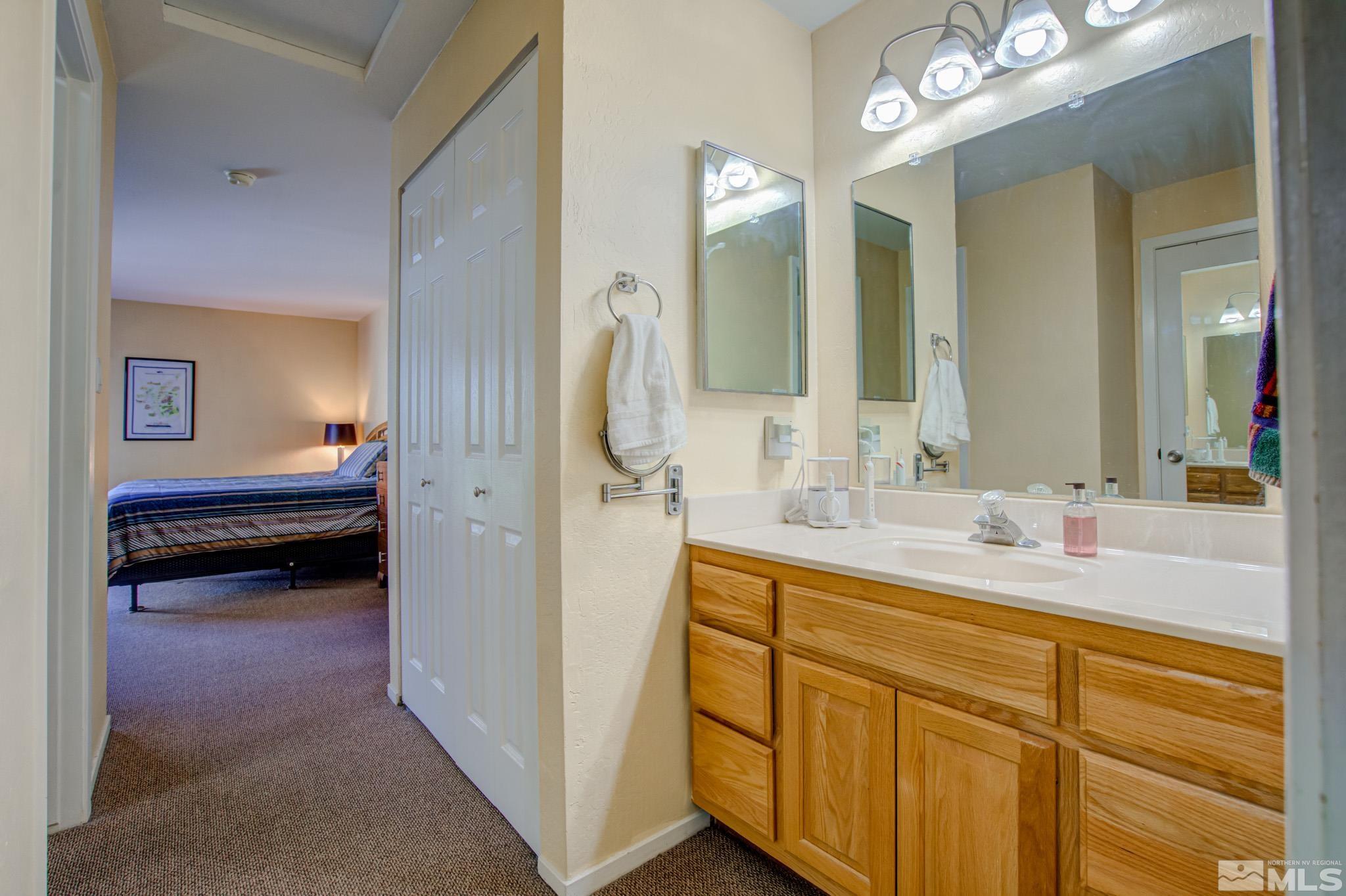 1208 Laredo Court Reno, NV 89503 - Photo 20 of 30 a en suite bathroom with a double vanity sink and a mirror