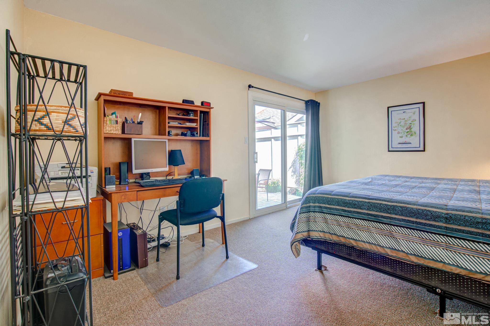 1208 Laredo Court Reno, NV 89503 - Photo 22 of 30 a bedroom with a bed and a bookshelf