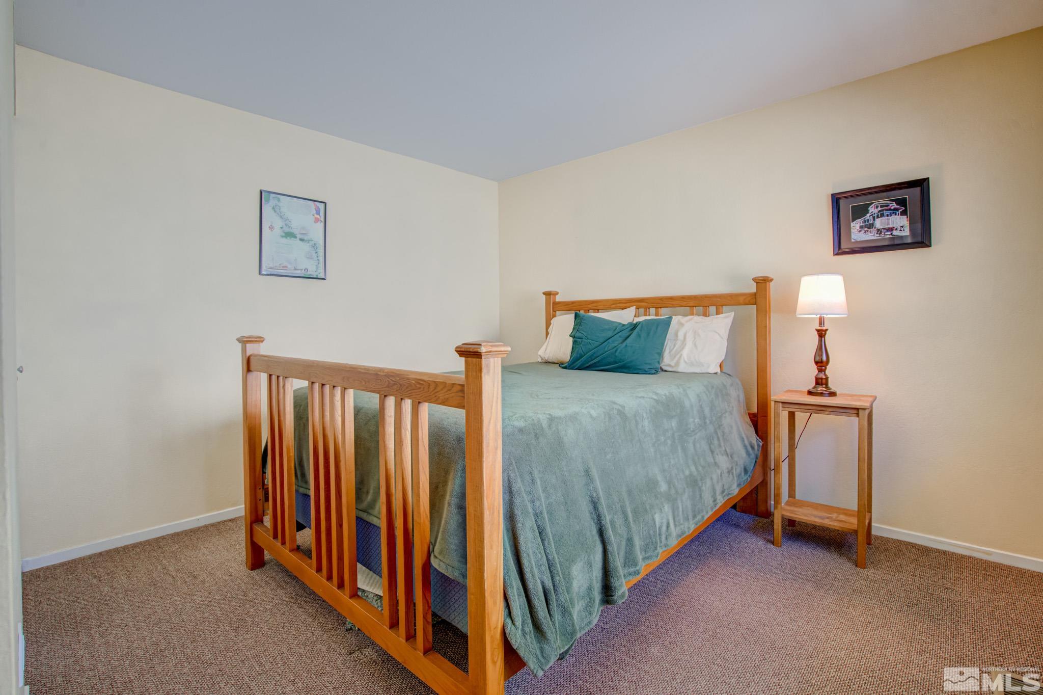 1208 Laredo Court Reno, NV 89503 - Photo 23 of 30 a bed room with a bed and a night stand