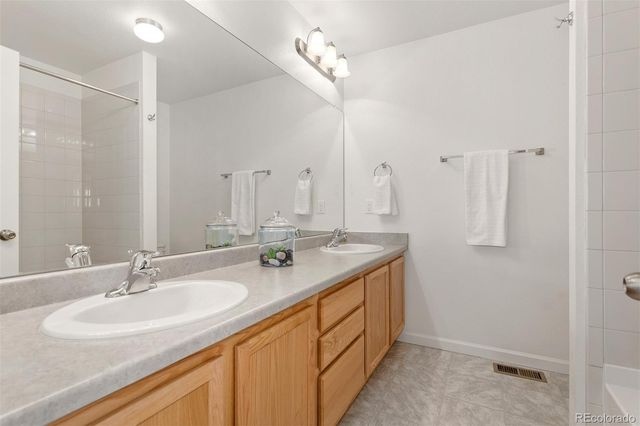 a bathroom with double sink and a mirror