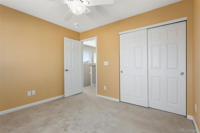 an empty room with a ceiling fan
