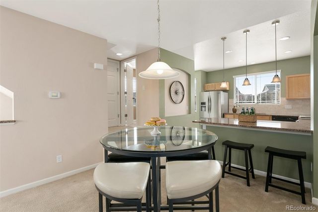 a view of a dining room and a table and chairs in the kitchen