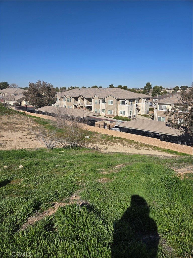 14140-14146 Rodeo Drive Victorville, CA 92395 - Photo 5 of 11 a view of a big house with a big yard and large trees