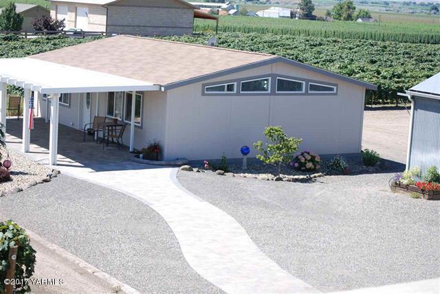 200 South Grey Road, Unit B Mabton, WA 98935 - Photo 1 of 5 a front view of a house with a yard and seating space