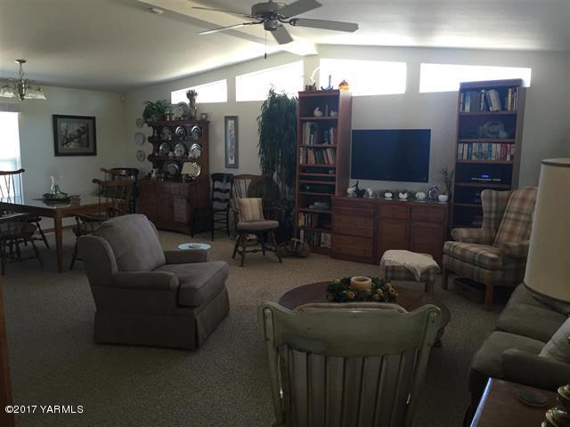 200 South Grey Road, Unit B Mabton, WA 98935 - Photo 3 of 5 a living room with furniture a large window and a flat screen tv