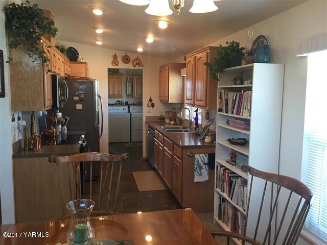200 South Grey Road, Unit B Mabton, WA 98935 - Photo 4 of 5 a kitchen with stainless steel appliances granite countertop a refrigerator and a stove