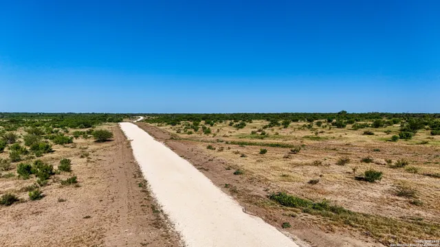 a sign board with a trees in the background
