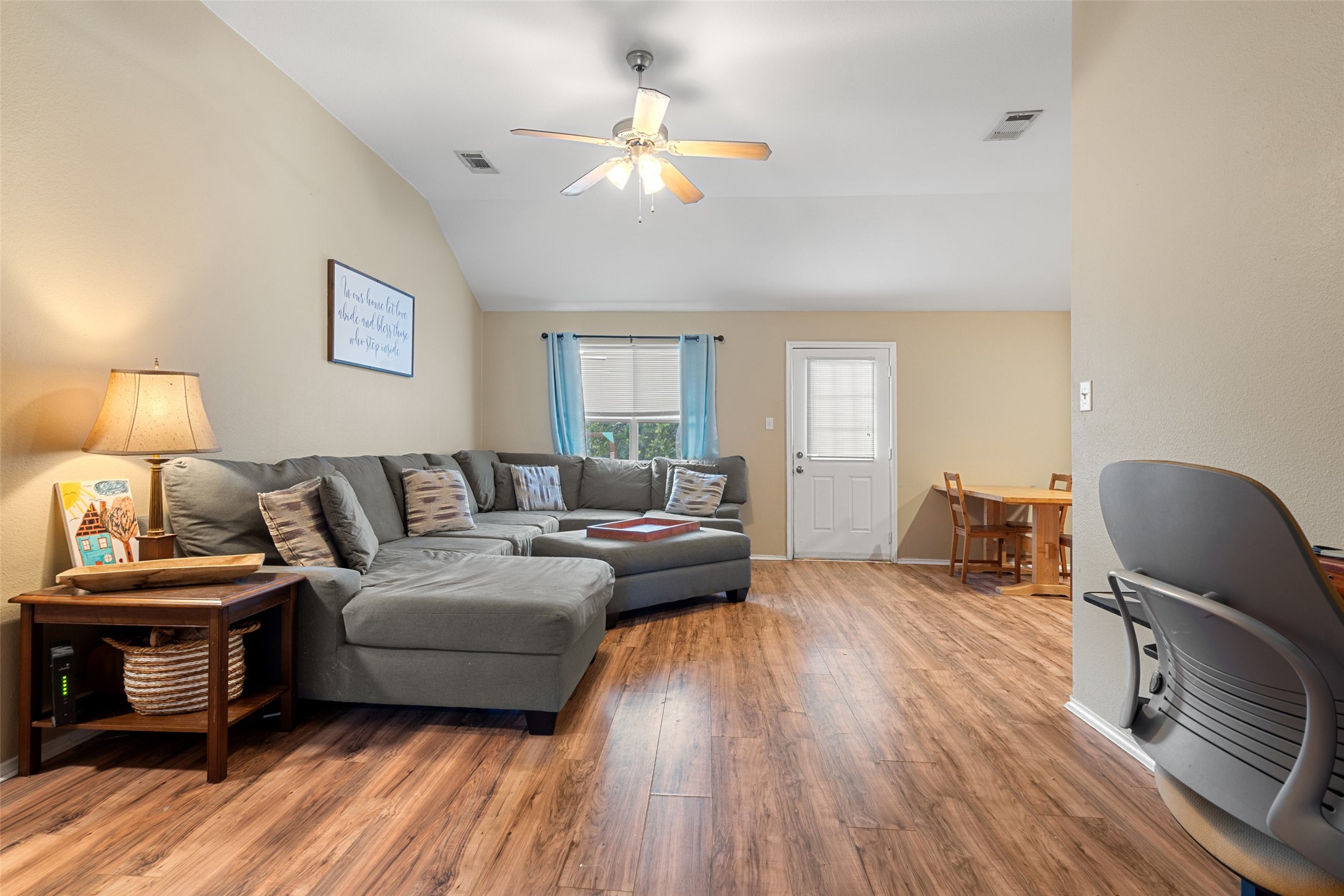 217 Moonstone Drive Jarrell, TX 76537 - Photo 1 of 1 a living room with furniture a lamp and a flat screen tv