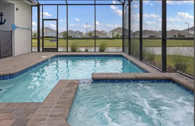 a view of a swimming pool with a from chair