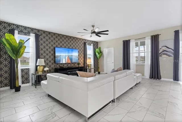 a living room with furniture a flat screen tv and a fireplace