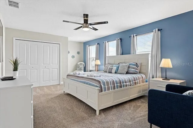 a spacious bedroom with a bed and a chandelier