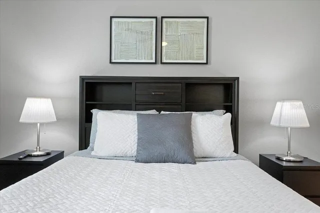 a bedroom with a bed and a lamp