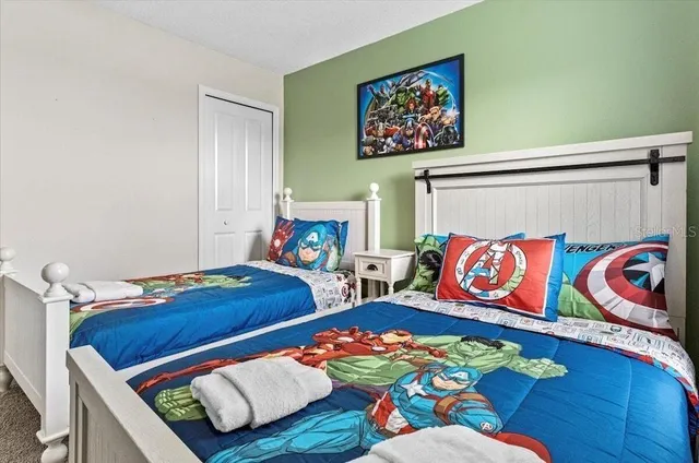 a bedroom with bed and a wooden floor