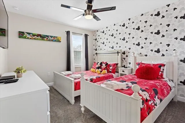 a bedroom with two beds and a dresser