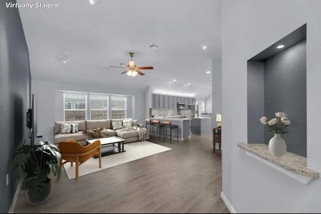 a living room with furniture and a large window