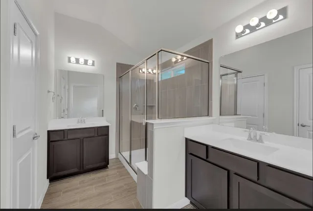 a bathroom with a sink double vanity and a mirror