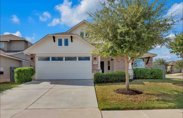 a front view of a house with garage