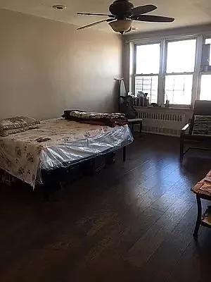 a bed sitting in a bedroom next to a window