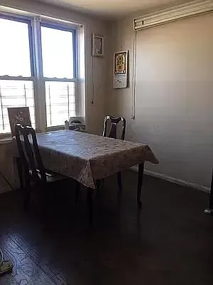 a dining room with a table chairs and a window