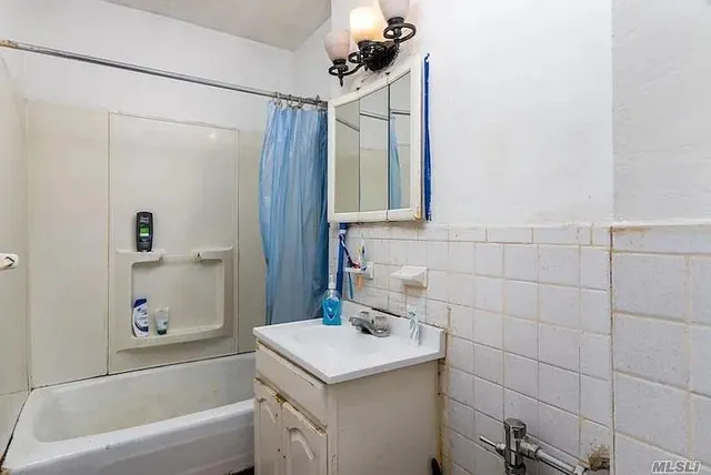 a bathroom with a bathtub a sink and a shower