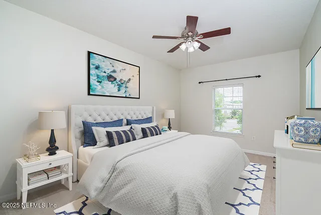 a bedroom with a bed and a painting on the wall