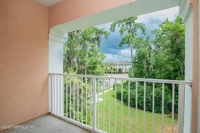 a view of a house with a patio and a yard